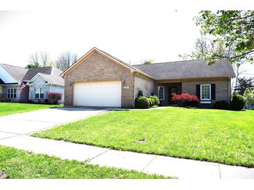Charming single-story brick home with an attached two-car garage and a well-manicured front lawn at 45 Golden Tree Ln, Indianapolis, IN 46227