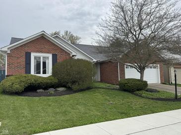 Charming single Gathering home featuring a brick exterior and manicured front yard at 4586 Aldersgate Dr, Carmel, IN 46033