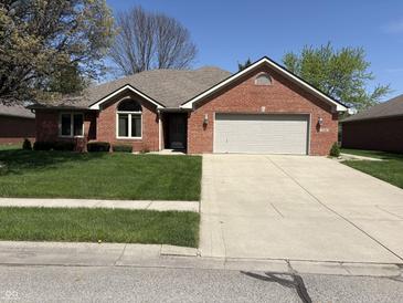 Charming single-story brick home with a well-maintained lawn and attached two-car garage at 5122 Montpelier Ct, Columbus, IN 47203