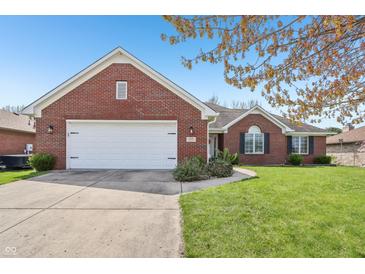 Charming brick home featuring an attached two-car garage and a well-maintained front yard at 5325 Tracey Jo Rd, Greenwood, IN 46142