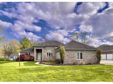 Attractive brick home with a well-manicured lawn and lovely landscaping at 5441 Red Hawk Ln, Greenwood, IN 46142
