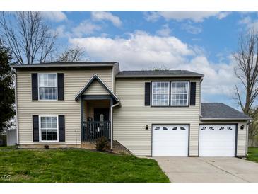 Charming two-story home featuring a welcoming entrance and an attached two-car garage at 8231 N Chaucer Ct, Columbus, IN 47201