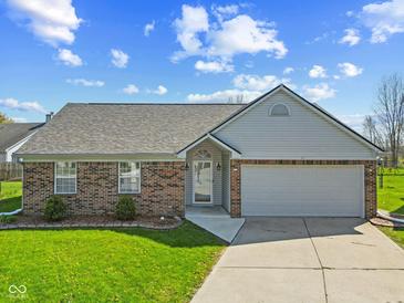Charming single-story home features a brick facade and attached two-car garage at 84 Beech Ct, Whiteland, IN 46184