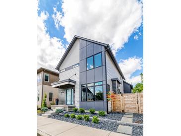 Modern two-story home with gray and white siding, black framed windows and a well-manicured front yard at 8740 Morgan Dr, Fishers, IN 46038