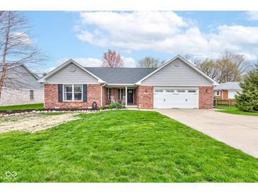 Charming brick home with a well-manicured lawn and an attached two-car garage at 1707 Lafayette Ave, Lebanon, IN 46052