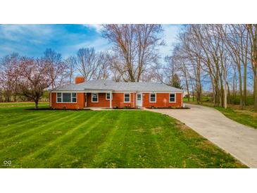 Charming red brick ranch home with a lush green lawn and mature trees at 1911 N Rangeline Rd, Anderson, IN 46012