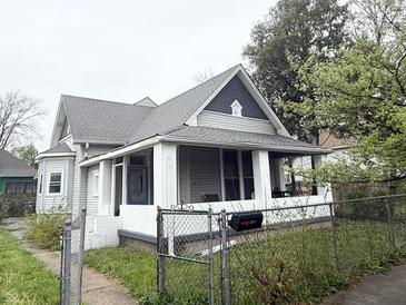 Charming home featuring a covered front porch, gray roof, and white painted brick at 2208 Avondale Pl, Indianapolis, IN 46218
