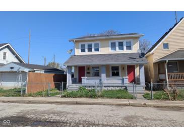 Charming two-story duplex with a fenced yard and inviting front porch at 408 E Beecher St, Indianapolis, IN 46225