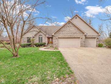 Charming brick home with attached two car garage and lush green lawn at 454 Roberson Blvd, Mooresville, IN 46158