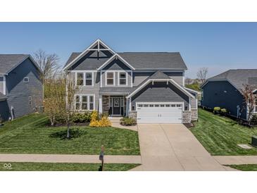 Beautiful two-story home featuring a manicured lawn, neutral siding, and an attached two-car garage at 6472 W Treeline Ln, McCordsville, IN 46055