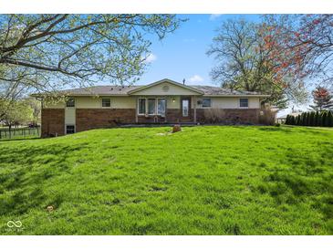 Well maintained single Gathering home with brick accents and a lush green lawn at 7482 N Maple Dr, Frankton, IN 46044