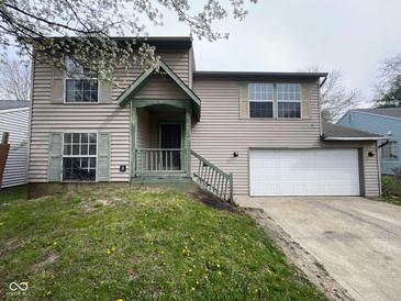 Charming two-story home features a front porch, attached garage, and pleasant curb appeal at 11106 Wismar Dr, Indianapolis, IN 46235