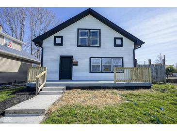Two-story home featuring black-framed windows, new porch, and black trimmed gabled roof at 2216 Bethel Ave, Indianapolis, IN 46203