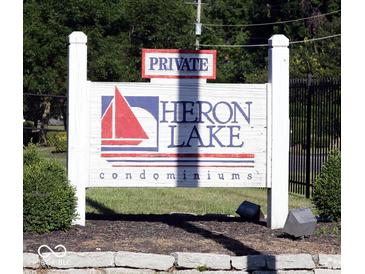 Private Heron Lake Condominiums sign with sailboat and lake in front of a wooded area at 3010 Lake Shore Dr # D, Indianapolis, IN 46205