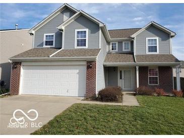 Charming two-story home featuring a spacious garage, neutral siding and brick accents at 3097 Limber Pine Dr, Whiteland, IN 46184