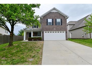 Two-story brick home with a large front yard and an attached two-car garage at 3930 Towhees Dr, Indianapolis, IN 46237