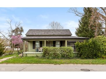 Charming single-story home with a covered front porch, landscaping, and inviting curb appeal at 415 S East St, Plainfield, IN 46168