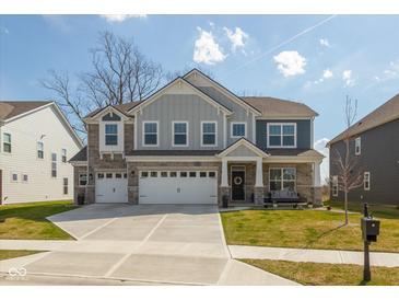 Beautiful two-story home with a three car garage, well maintained lawn, and stone accents at 4333 Ironclad Dr, Bargersville, IN 46106