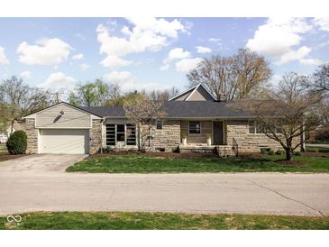 Charming ranch-style home with stone exterior and attached two-car garage at 5802 Crittenden Ave, Indianapolis, IN 46220