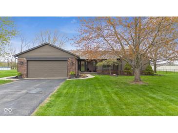Charming home with a brick and siding exterior, well-manicured lawn, and paved driveway at 5925 Leisure Ln, Pittsboro, IN 46167