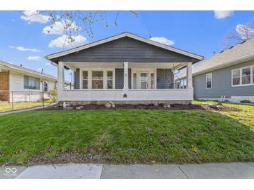 Charming home featuring a covered front porch and well-manicured lawn, creating a welcoming curb appeal at 67 S 9Th Ave, Beech Grove, IN 46107