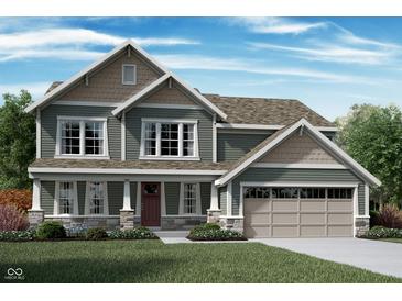 Charming two-story home with a large two car garage, manicured lawn and lovely stone and siding details at 1065 Christopher Ct, Greenwood, IN 46143