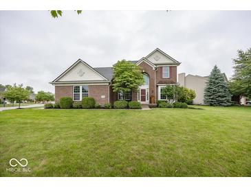 Charming brick two-story home with a well-manicured lawn and mature landscaping at 11648 Stickney Ct, Fishers, IN 46037