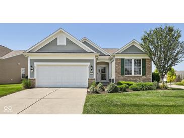 Charming home with landscaped front yard, two-car garage, and a welcoming entrance at 12907 Shiraz Ln, Fishers, IN 46037