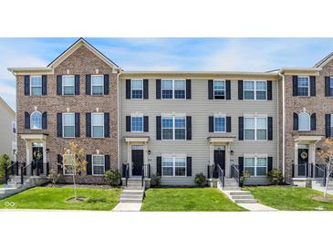 Charming townhouse with manicured lawn, contrasting brick and siding, and classic black shutters at 17269 Dallington St, Westfield, IN 46074
