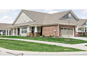 Charming home with a brick facade, covered porch, and well-manicured lawn at 17302 Graley Pl, Westfield, IN 46074
