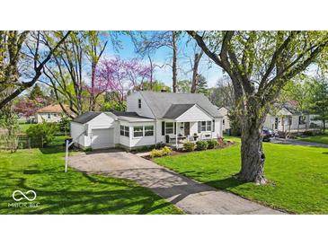 Charming home with a well-manicured lawn, attached garage, and inviting curb appeal at 2204 Pamela Dr, Indianapolis, IN 46220