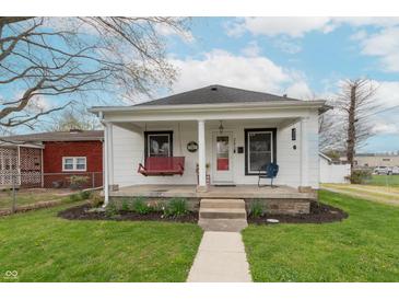 Charming single-story home featuring a covered front porch with a swing, walkway, and well-maintained lawn at 282 N Mapleton St, Columbus, IN 47201