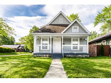 Charming home featuring a covered front porch, well-maintained lawn, and classic architectural details at 3031 Nowland Ave, Indianapolis, IN 46201