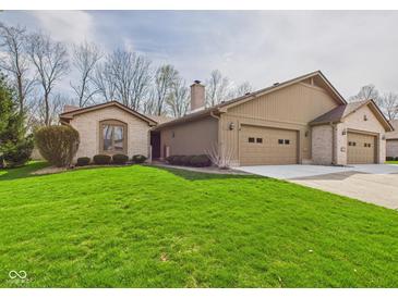 Charming single-story home featuring a brick facade, attached garage and well-maintained lawn at 3629 Woodglen Way, Anderson, IN 46011