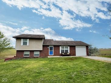 Attractive exterior view of this charming property, featuring lush green lawn at 3703 E Gore St, Columbus, IN 47201