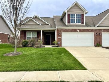 Inviting single-Gathering home featuring an attached two-car garage and well-maintained lawn in a suburban neighborhood at 4327 Switchgrass Way, Indianapolis, IN 46237