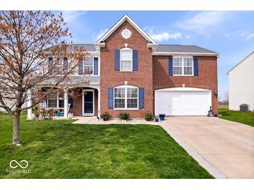 Charming two-story brick home with a well-manicured lawn and attached two-car garage at 4922 Birmingham Dr, Indianapolis, IN 46235