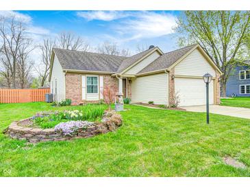 Charming home with well-maintained lawn, brick accents, and vibrant flower garden at 5126 Shadow Pointe Dr, Indianapolis, IN 46254