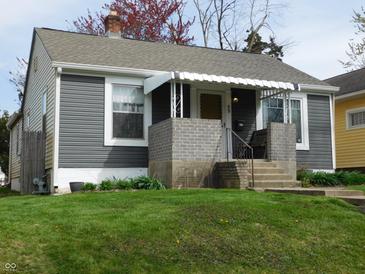 Charming single-story home with gray siding, a brick porch, and a well-manicured lawn at 59 N Ridgeview Dr, Indianapolis, IN 46219