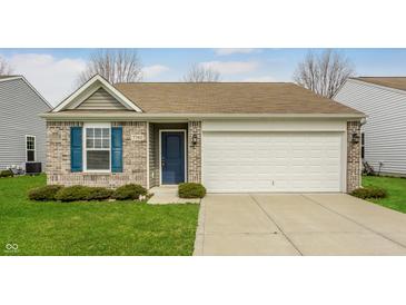 Charming single-story home featuring a brick facade, attached two-car garage, and a well-manicured front lawn at 7782 Rose Ln, Ingalls, IN 46048