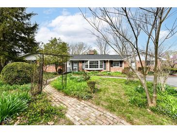Charming brick home with a landscaped front yard and brick walkway leading to the entrance at 80 S Richland Ave, Carmel, IN 46032
