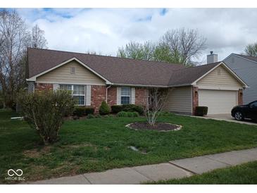 Charming single-story brick home with a well-manicured lawn and attached garage at 8106 Captain Dr, Avon, IN 46123
