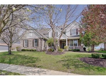 Charming two-story home featuring a combination of brick and siding, complemented by a well-manicured lawn and mature trees at 16994 Folly Brook Rd, Noblesville, IN 46060