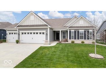 Charming single-story home featuring a manicured lawn, a two-car garage, and a welcoming entryway at 19283 Donelson Ln, Westfield, IN 46062