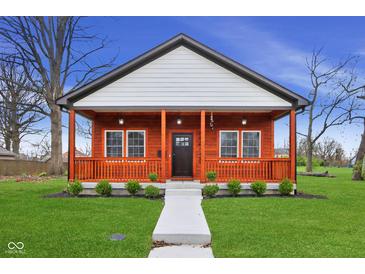 Charming home with a inviting front porch, updated landscaping, and a lovely walkway at 2428 N Gale St, Indianapolis, IN 46218