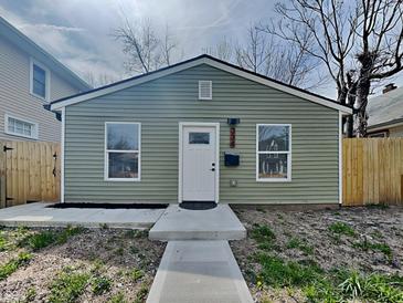Charming home featuring a freshly painted exterior, new walkway, and manicured landscaping, creating curb appeal at 334 N Chester Ave, Indianapolis, IN 46201