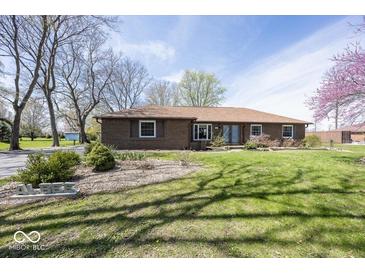 Charming brick home with well-maintained lawn and mature trees at 506 N County Road 900 E, Avon, IN 46123