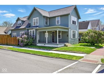 Charming two-story home with a covered porch with simple white pillars and a well-maintained front yard at 516 S 10Th St, Noblesville, IN 46060