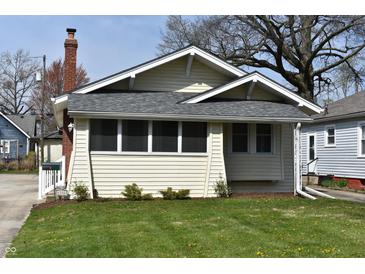 Charming home featuring a manicured lawn, inviting facade, and craftsman architectural details at 6186 Ralston Ave, Indianapolis, IN 46220