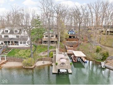 Stunning aerial view of lakefront homes with private docks and boat slips surrounded by mature trees at 6948 Eagle Dr, Nineveh, IN 46164